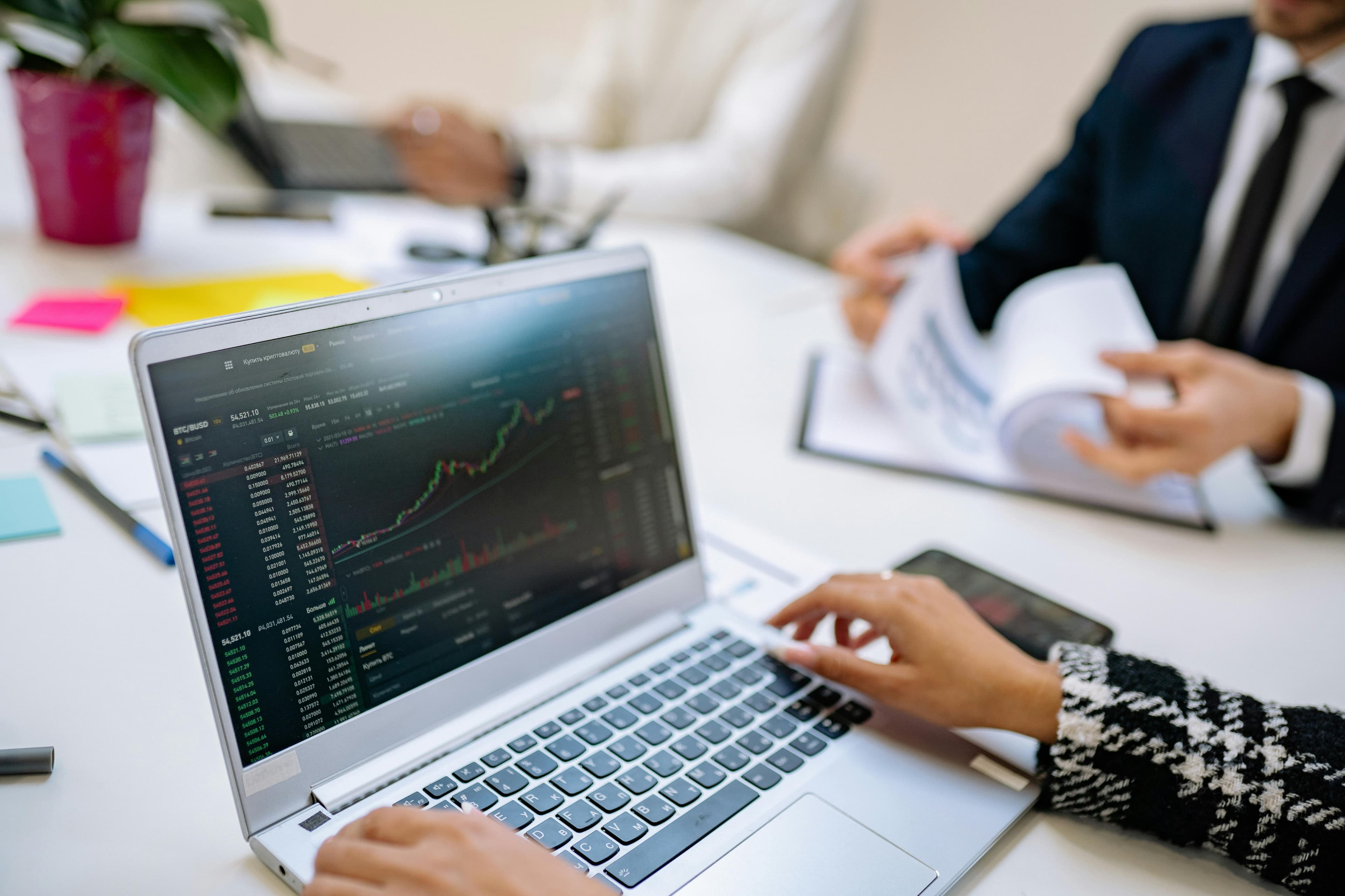 Business team reviewing analytics on a laptop during a strategy meeting